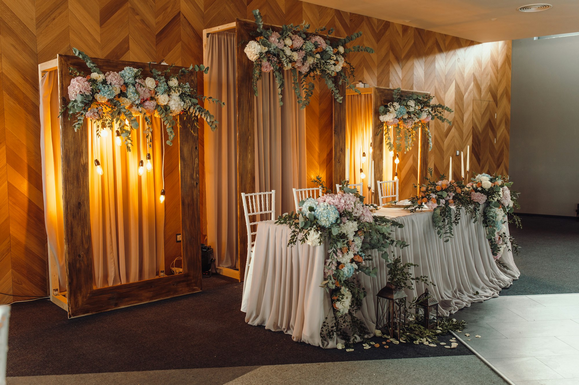 Dreamy Wedding Decor. Lavish floral decorations set against a rustic backdrop